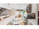 Bright kitchen with stainless steel appliances and decor, complemented by a cozy breakfast nook at 2022 S Helena St # G, Aurora, CO 80013