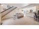 Spacious living room featuring neutral tones, staircase, and an open view of the modern kitchen at 2022 S Helena St # G, Aurora, CO 80013