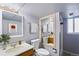 Bright bathroom featuring a vanity, toilet, and shower with modern fixtures and light gray walls at 14453 W 3Rd Ave, Golden, CO 80401