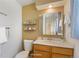 Bathroom featuring a vanity with a sink, decorative shelves, and a well-lit mirror at 14453 W 3Rd Ave, Golden, CO 80401