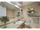 Bright bathroom featuring a vanity with a sink, shelves, and a shower with tiled walls at 14453 W 3Rd Ave, Golden, CO 80401