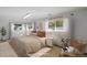 Staged bedroom featuring neutral tones, large windows, and stylish decor elements for a comfortable living space at 14453 W 3Rd Ave, Golden, CO 80401