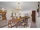Elegant dining room featuring a large table, stylish chairs, and a view into the staged living room and kitchen at 14453 W 3Rd Ave, Golden, CO 80401