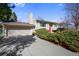 Charming two-story home featuring a red front door and a well-maintained front yard with mature bushes at 14453 W 3Rd Ave, Golden, CO 80401