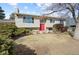 Charming exterior view of a two-story home featuring well-maintained landscaping and a red front door at 14453 W 3Rd Ave, Golden, CO 80401