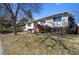 Well-maintained front yard with mature trees, attractive landscaping and a bright red front door at 14453 W 3Rd Ave, Golden, CO 80401