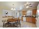 Inviting kitchen featuring tile floors, wooden cabinets, modern appliances, and a cozy dining area with a stylish table at 14453 W 3Rd Ave, Golden, CO 80401