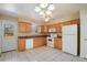 Bright kitchen with light wood cabinets, white appliances, and a window over the sink at 14453 W 3Rd Ave, Golden, CO 80401