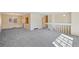 Open-concept living room with neutral carpeting, a large window, and a view into the dining area, perfect for entertaining at 14453 W 3Rd Ave, Golden, CO 80401