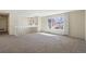 Spacious living room with a large window, neutral carpeting, and ample natural light, creating a comfortable atmosphere at 14453 W 3Rd Ave, Golden, CO 80401