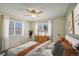 Serene bedroom with large windows, a ceiling fan, and light-colored walls at 14453 W 3Rd Ave, Golden, CO 80401