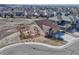 Captivating aerial shot of a brick and tan home nestled in a vibrant community, with a lush green space at 4883 S Sicily St, Aurora, CO 80015