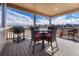 Relaxing outdoor space with a BBQ grill, dining table and comfortable seating overlooking the scenery at 4883 S Sicily St, Aurora, CO 80015