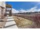 A backyard with stairs leading up to the house and a view of the community at 4883 S Sicily St, Aurora, CO 80015