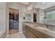 Elegant bathroom featuring double sinks, a walk-in closet and modern fixtures at 4883 S Sicily St, Aurora, CO 80015
