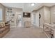 Open bedroom with neutral walls and carpet with a console and large TV screen at 4883 S Sicily St, Aurora, CO 80015