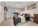 Modern bedroom featuring a bed, desk setup, ceiling fan, and a large window at 4883 S Sicily St, Aurora, CO 80015