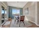 Bright dining room with large windows and sliding door to the outside patio at 4883 S Sicily St, Aurora, CO 80015