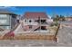 Exterior angle of the house featuring a balcony with stairs and a manicured backyard at 4883 S Sicily St, Aurora, CO 80015
