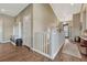 Welcoming foyer with hardwood floors, a coat rack, and a view into a well-lit living space at 4883 S Sicily St, Aurora, CO 80015