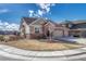Charming ranch-style home with a brick and tan exterior, three-car garage, and well-maintained front yard at 4883 S Sicily St, Aurora, CO 80015