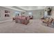 Expansive basement living room with plush carpeting and comfortable leather seating area at 4883 S Sicily St, Aurora, CO 80015