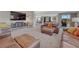 Spacious basement area with leather couches, entertainment center, and access to an additional room at 4883 S Sicily St, Aurora, CO 80015