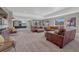 Large basement living area with comfortable leather furniture, windows, and recessed lighting at 4883 S Sicily St, Aurora, CO 80015
