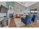 Cozy living room featuring a fireplace, large windows, hardwood floors, and a comfortable seating area at 4883 S Sicily St, Aurora, CO 80015