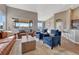 Open-concept living room with hardwood floors, a fireplace, comfortable seating, and a view into the kitchen at 4883 S Sicily St, Aurora, CO 80015