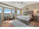 Comfortable main bedroom featuring a large bed, ample natural light, and a ceiling fan at 4883 S Sicily St, Aurora, CO 80015