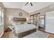 Spacious main bedroom with modern decor, large bed, and access to the bathroom at 4883 S Sicily St, Aurora, CO 80015