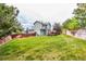 Backyard with green grass with a view of a two story home with green siding at 21396 E Prentice Ln, Centennial, CO 80015