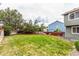 Spacious backyard featuring a well-maintained lawn, privacy fence, and mature trees providing shade at 21396 E Prentice Ln, Centennial, CO 80015