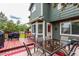 Outdoor deck with a grill and dining set, adjacent to a green backyard at 21396 E Prentice Ln, Centennial, CO 80015