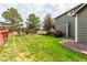 Lush backyard with a well-kept lawn, wooden deck, and garden area, perfect for outdoor enjoyment at 21396 E Prentice Ln, Centennial, CO 80015