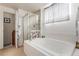 Bright bathroom featuring a soaking tub, glass shower, and neutral decor at 21396 E Prentice Ln, Centennial, CO 80015