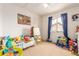 Bright bedroom with toys and blue curtains, and neutral carpet at 21396 E Prentice Ln, Centennial, CO 80015