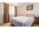 Comfortable bedroom featuring a queen size bed, soft lighting, and neutral decor at 21396 E Prentice Ln, Centennial, CO 80015