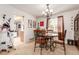 Bright dining room with a modern chandelier and backyard views through large window at 21396 E Prentice Ln, Centennial, CO 80015