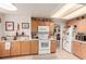 Bright kitchen features light-wood cabinets, white appliances, and tiled flooring, perfect for culinary adventures at 21396 E Prentice Ln, Centennial, CO 80015