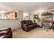 Open living room with a large leather sofa, adjacent to the kitchen creates a cohesive and inviting space at 21396 E Prentice Ln, Centennial, CO 80015