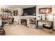 Cozy living room with a fireplace and large TV creates a welcoming space for relaxation and entertainment at 21396 E Prentice Ln, Centennial, CO 80015