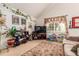 Spacious living room with a vaulted ceiling, large window, and lots of natural light at 21396 E Prentice Ln, Centennial, CO 80015