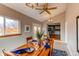 Sunlit dining room with wooden table, and view into the kitchen at 867 S Everett St, Lakewood, CO 80226