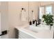 Bathroom with a white countertop, gray cabinets, and a black faucet with a white towel hanging near the mirror at 1433 Xavier St, Denver, CO 80204