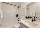 Well-lit bathroom featuring white subway tile, modern fixtures, and a combined bathtub and shower, offering a clean aesthetic at 1433 Xavier St, Denver, CO 80204