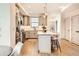 Bright kitchen with stainless steel appliances, a center island with seating, and ample cabinet space at 1433 Xavier St, Denver, CO 80204