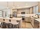 Modern kitchen featuring stainless steel appliances, gray cabinetry, and a stylish island with seating at 1433 Xavier St, Denver, CO 80204