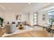 A modern living room with hardwood floors, gray sofa, round coffee table, and a view of the dining area at 1433 Xavier St, Denver, CO 80204